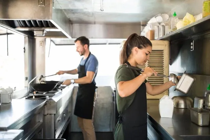 Two chefs working in a commercial kitchen