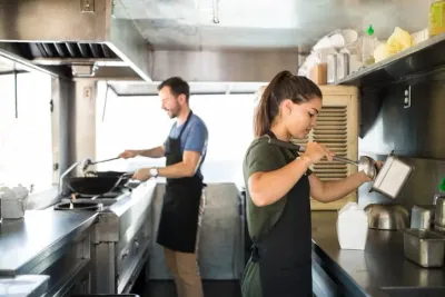 Two chefs working in a commercial kitchen