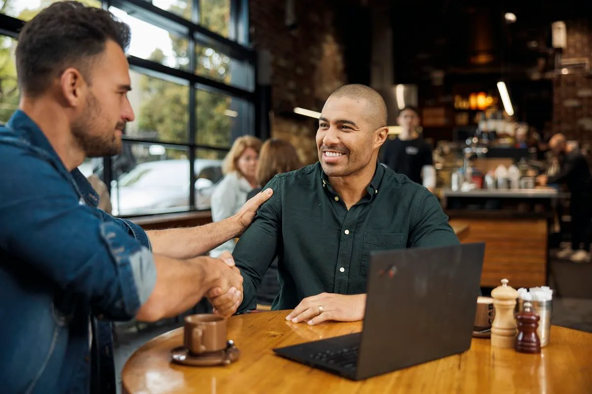 Two men shaking hands on a business purchase